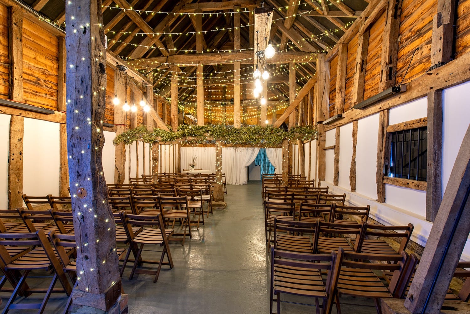 The Apple Barn laid out for a large seated celebration at The BarnYard