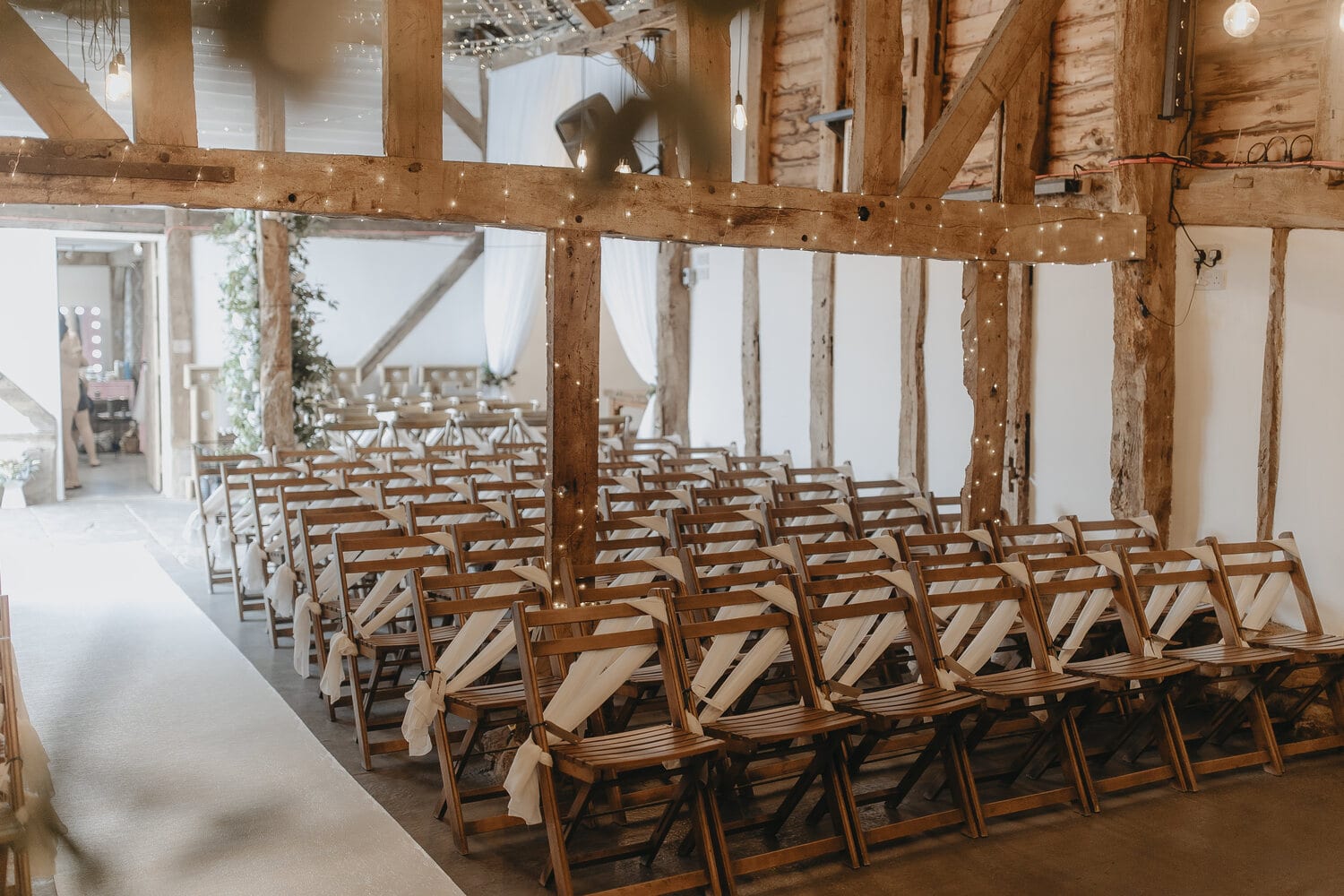 The Apple Barn set with rows of chairs and a foliage arch for a ceremony