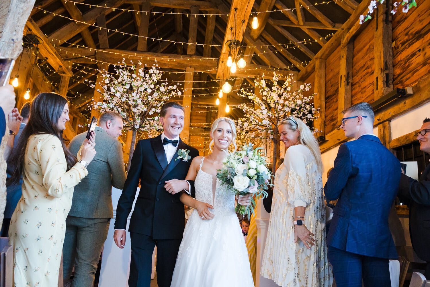 A white-floral ceremony underway in the Apple Barn