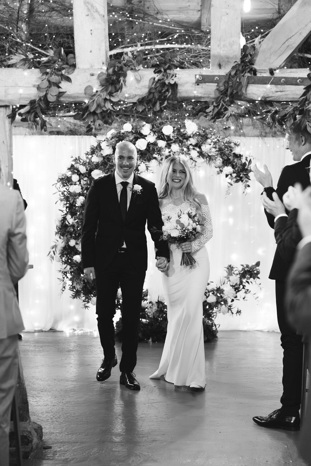 A black and white moment from an Apple Barn wedding ceremony