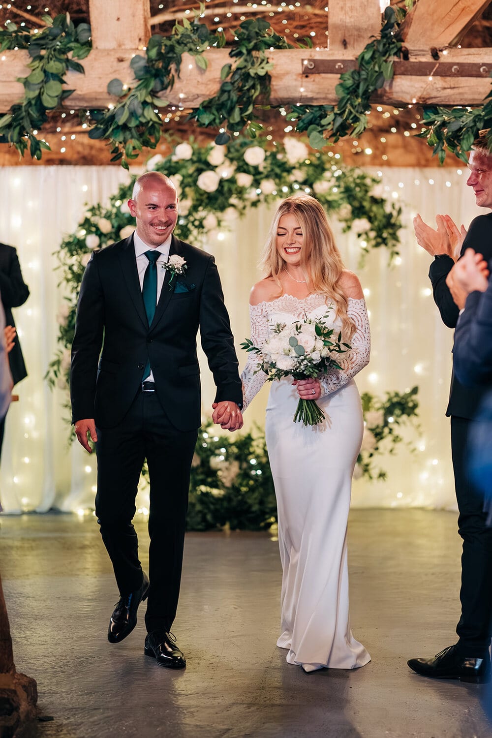 A couple celebrate just married in the Apple Barn
