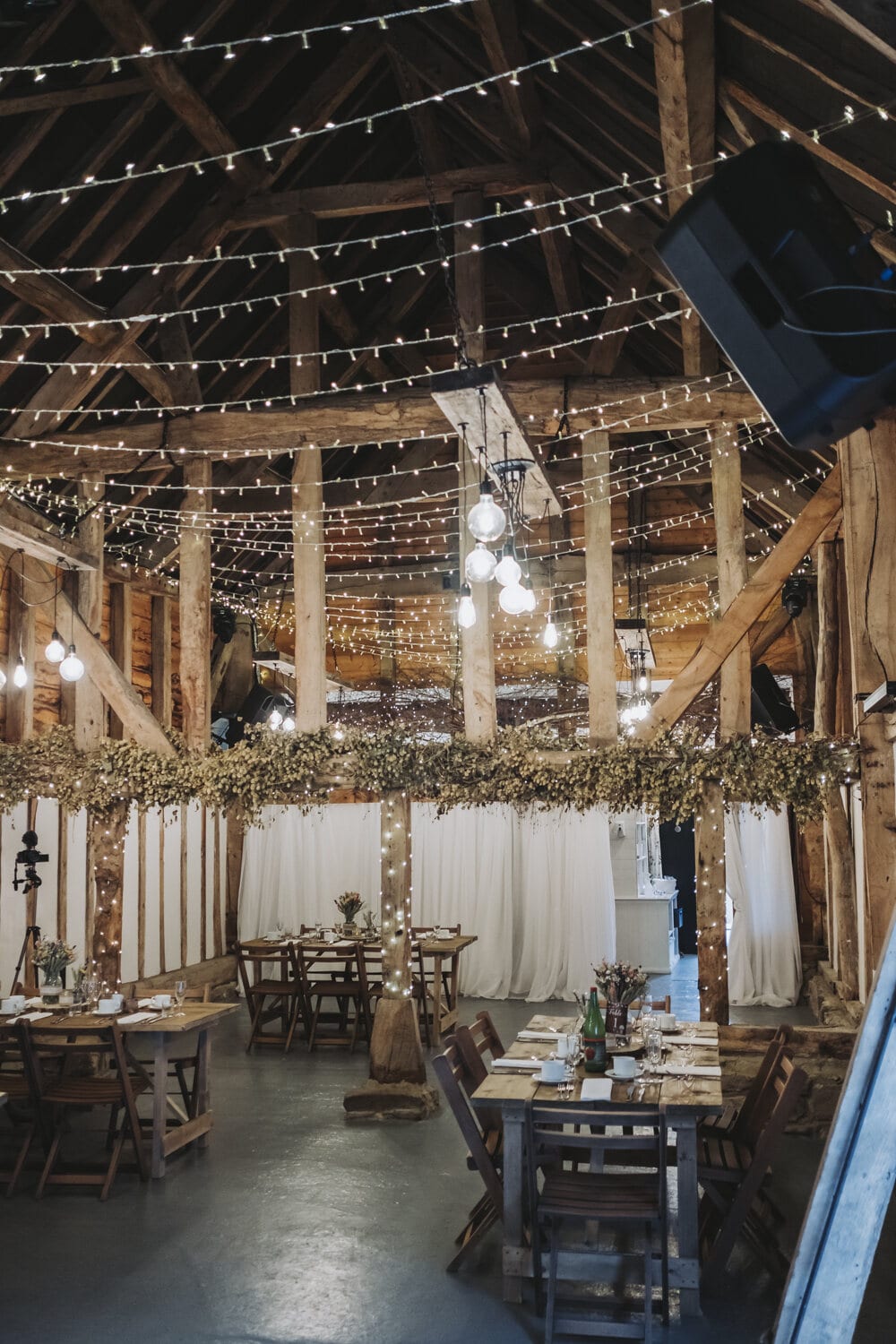 The Apple Barn glowing with fairy lights for an evening reception