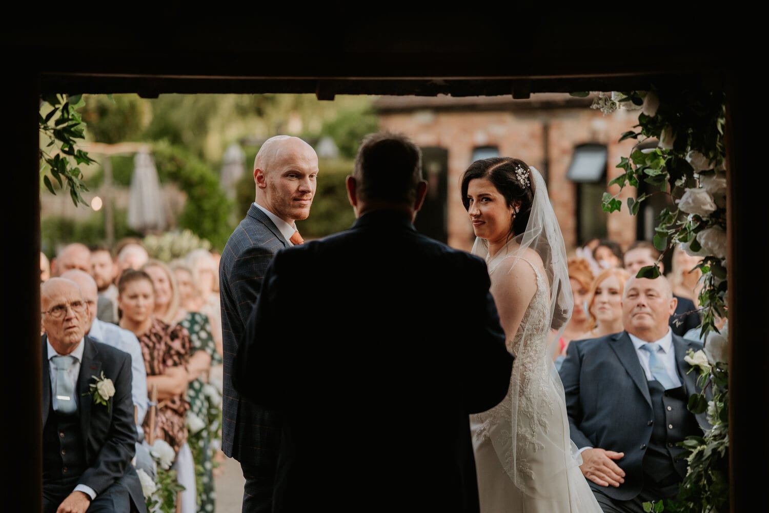 A courtyard ceremony lit with festoon and fairy lights
