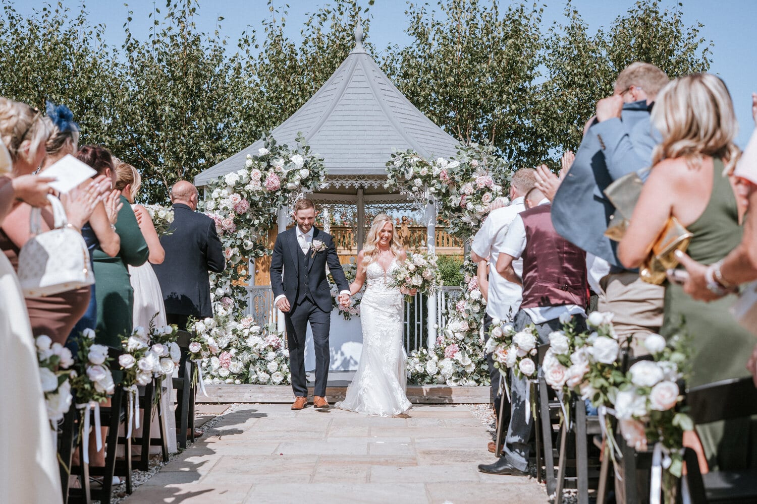 A ceremony underway at the lavender walk gazebo with guests seated