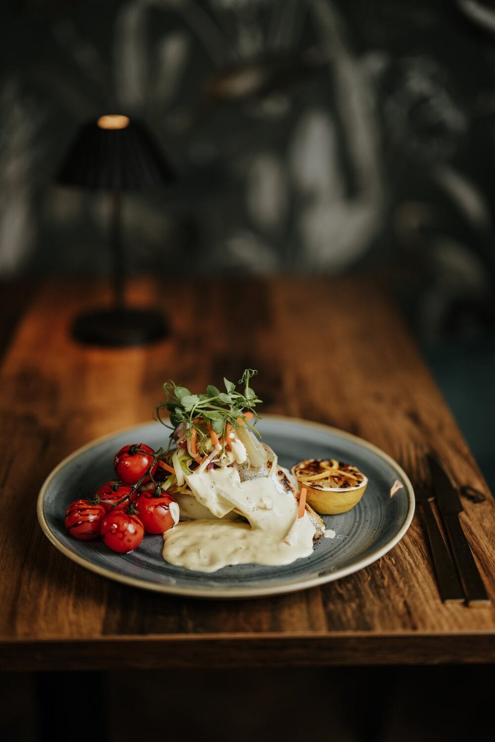 A plated main course on a slate-grey plate