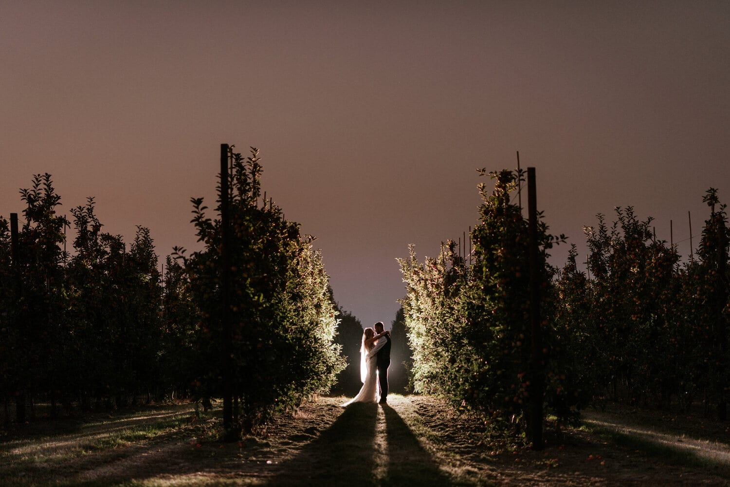 A couple on a path through the grounds at golden hour