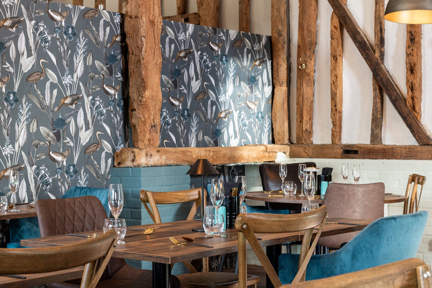 Blue dining chairs and rustic walls at The Rooster