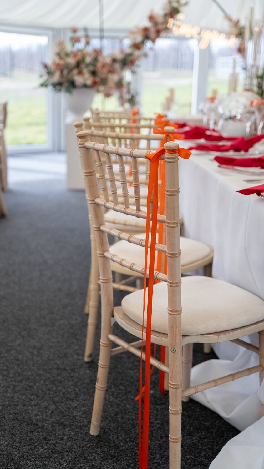 A neutral place setting with candles and flowers