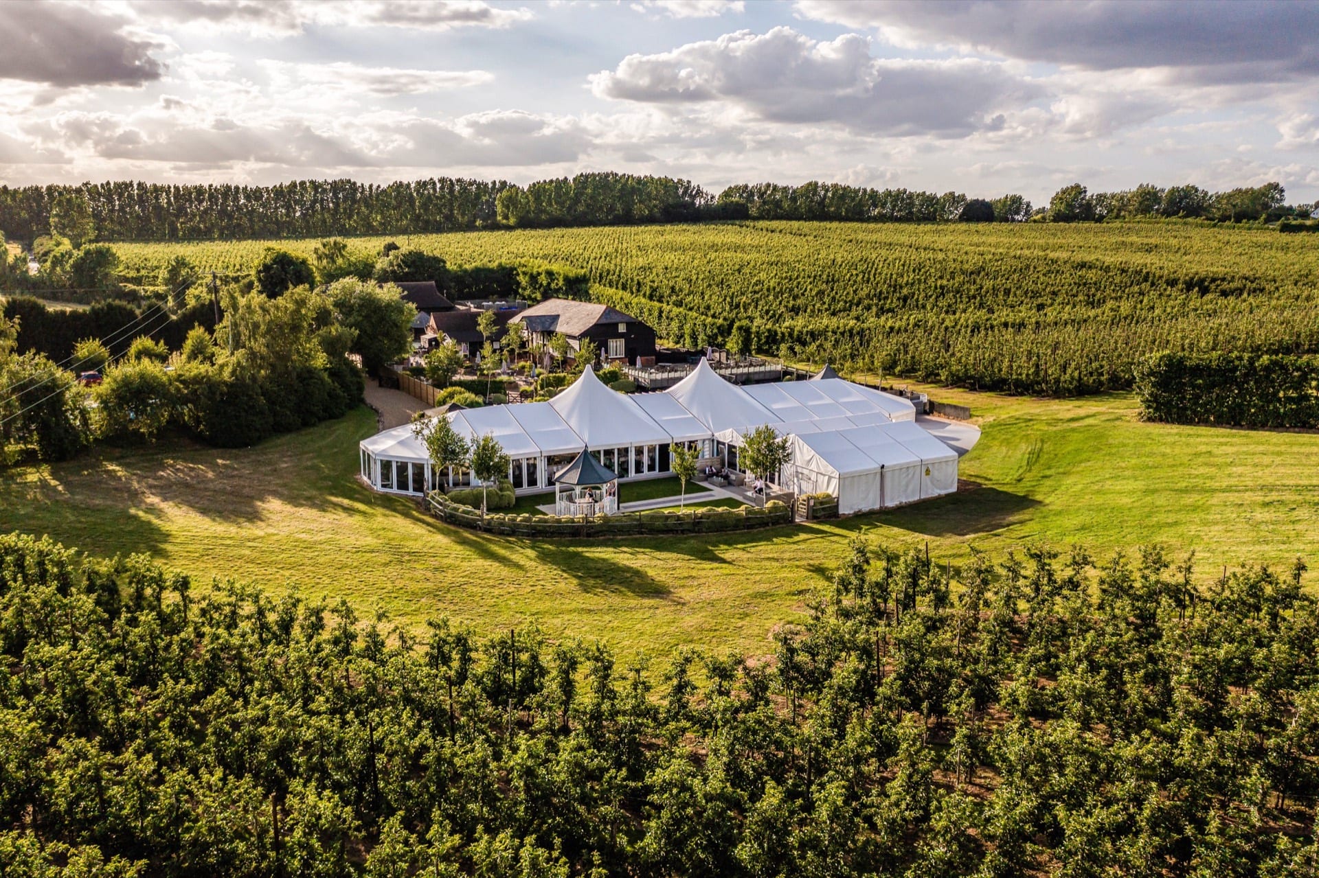 The BarnYard and its orchards from the air on a summer evening