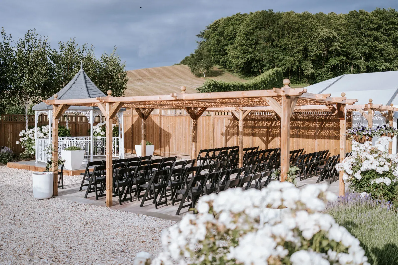 An outdoor wedding ceremony set up in the grounds at The BarnYard
