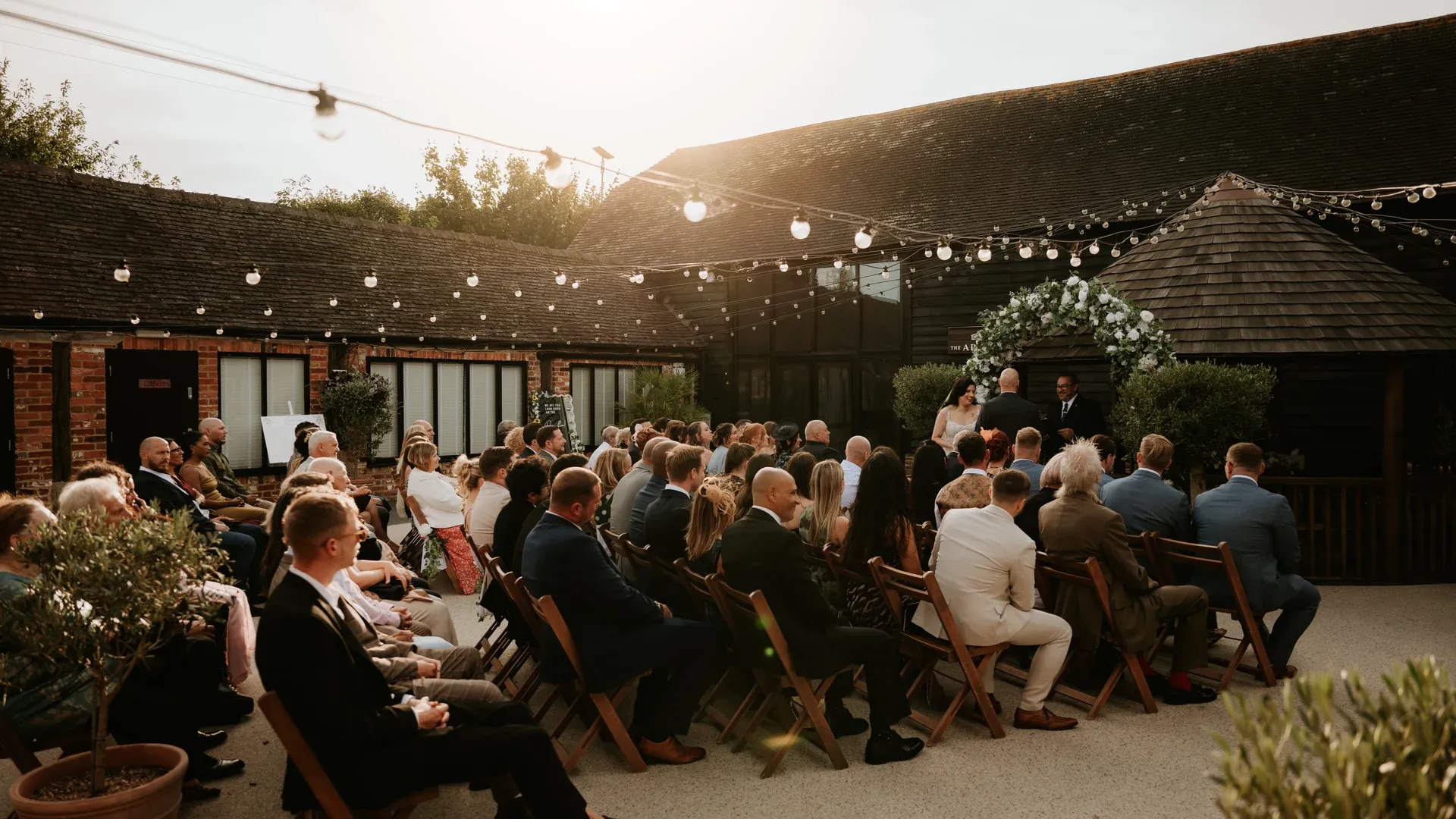 A twilight wedding ceremony in the Apple Barn courtyard at The BarnYard