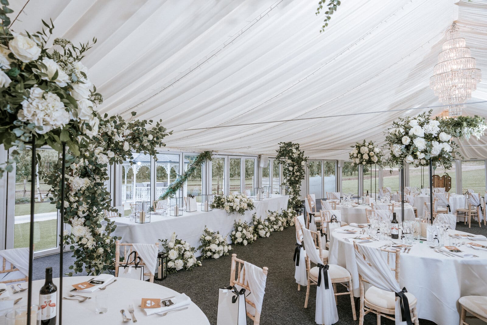 The marquee at The BarnYard dressed with banquet tables and florals for a wedding